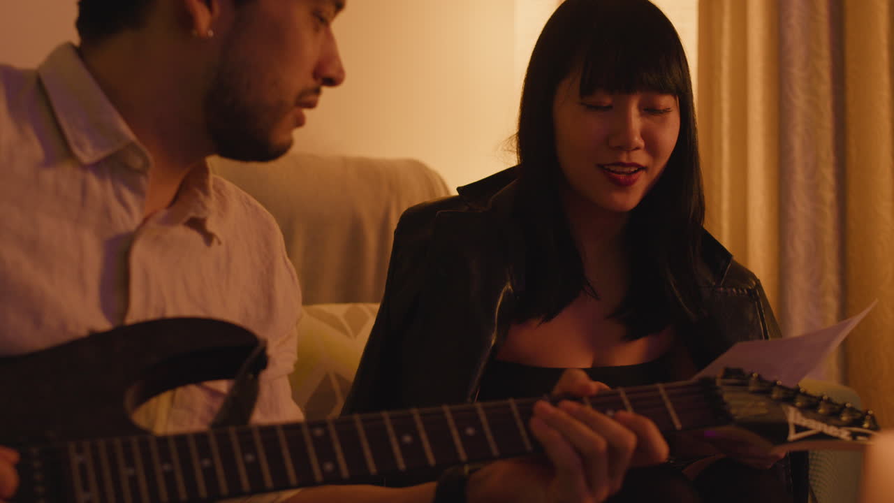 A man and a woman having a conversation while playing music