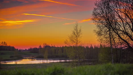 bright orange sky of sunrise over the country - time lapse