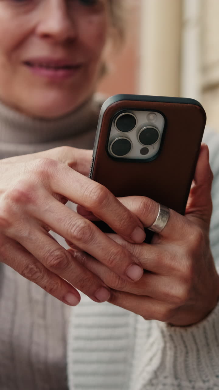 Close-up of Woman's Hands Tapping on a Smartphone Screen
