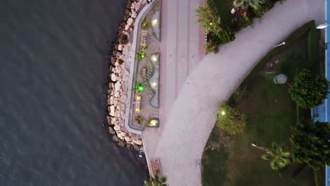 drone top footage of embankment among sea and car road at summer day