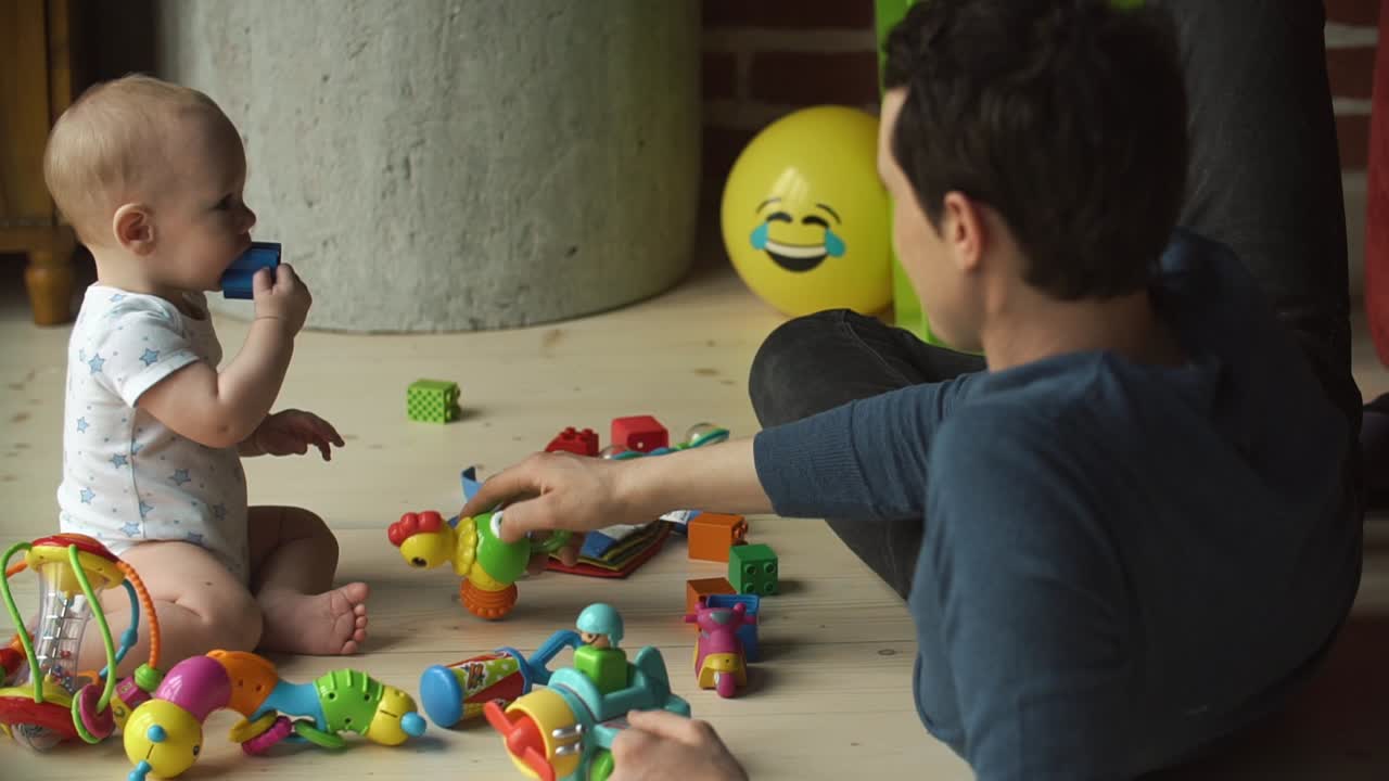 Father and baby playing with toys