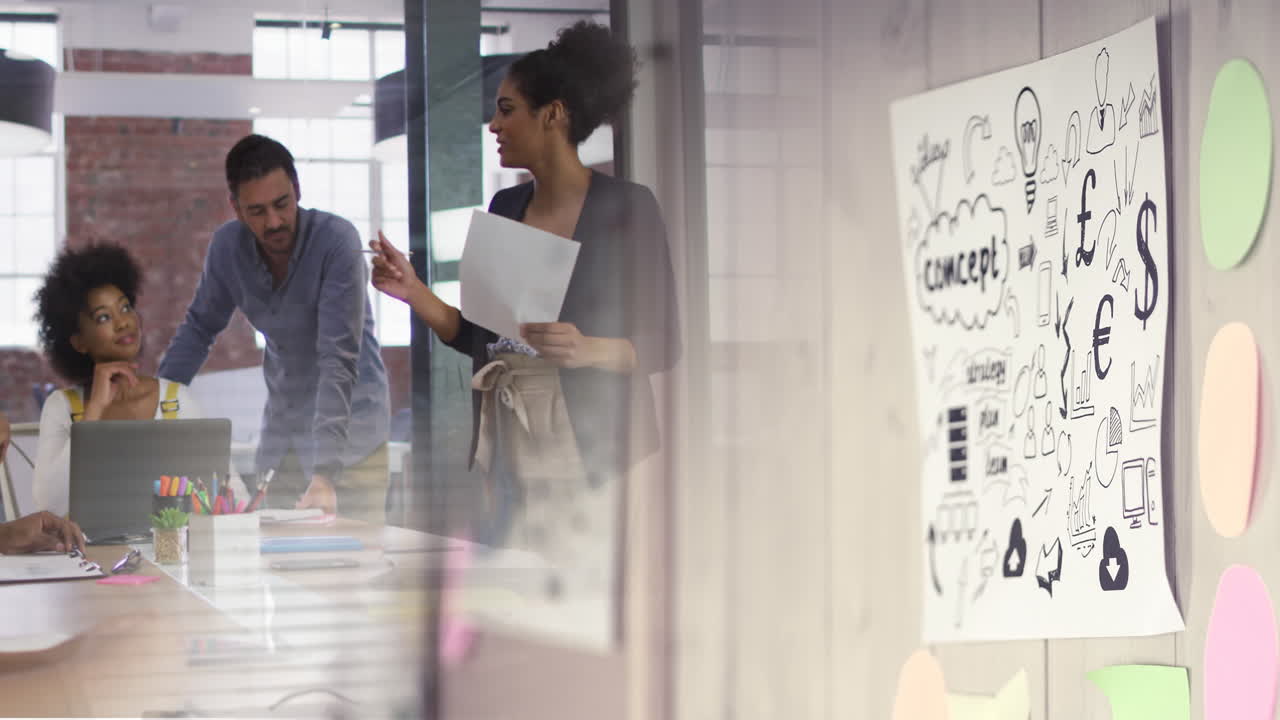 Animation of wall with concept on paper over diverse group of business people