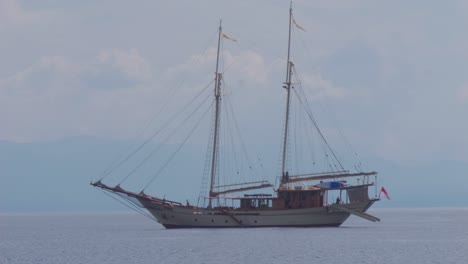 two-masted sailboat anchored near kri island, raja ampat, indonesia