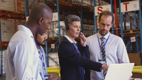 managers and staff having a meeting in a warehouse loading bay 4k