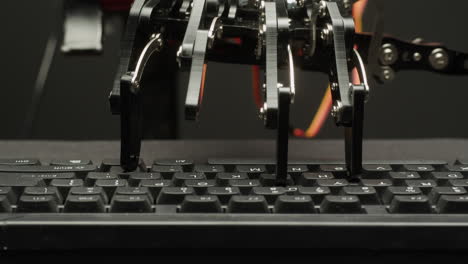 robot hand typing on a keyboard