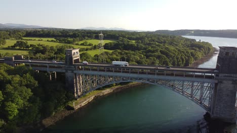 Aerial-view-of-Menai-Straits-Pont-Britannia-bridge-with-clear-turquoise-Swellies-river-rushing-underneath