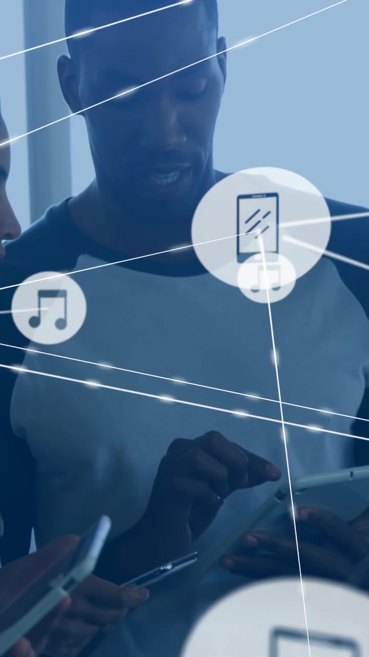 Vertical video: Man tapping tablet, tech team joining, swiping as nodes linking phones and sharing