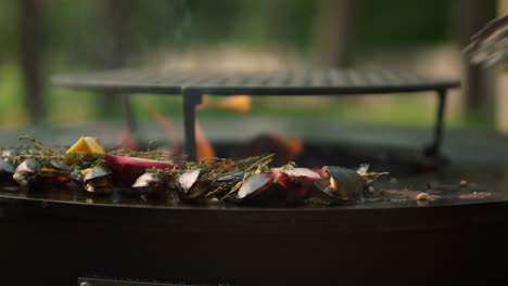 Man-picking-up-mussels-from-grill-outdoors.-Man-taking-seafood-from-bbq-grill