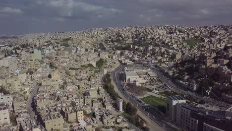 beautiful aerial clip overcast day of gray skies over amman jordan showing the city's multi-tiered architecture and landscape - taken by a drone