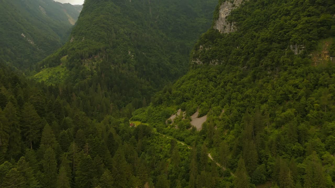 A peaceful village hidden among the Dolomite mountains from above.