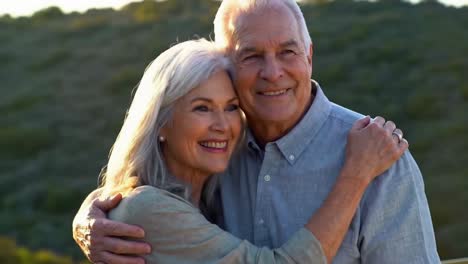 joyful senior caucasian couple embracing outdoors at golden hour