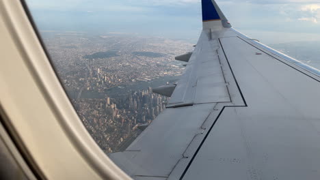 airplane pov flying over downtown manhattan, new york city, u.s.a.