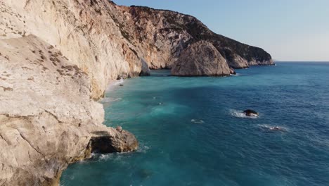 Beautiful-and-wild-rock-formations-on-iconic-turquoise-waters-of-Porto-Katsiki-beach-on-the-coastline-of-the-Aegean-sea-in-Lefkada,-Greece