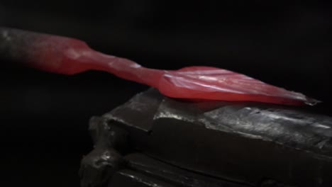 the blacksmith strikes hot metal with a hammer