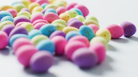 close up of multiple colorful easter eggs on white background