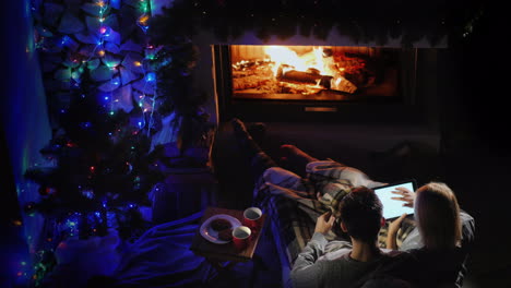 Young-Couple-Admires-The-Fire-In-The-Fireplace-Top-View