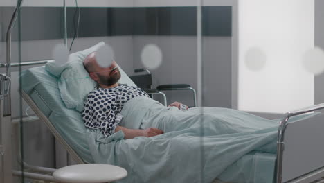 sick man resting in bed wearing nasal oygen tube waiting practitioner doctor for disease examination