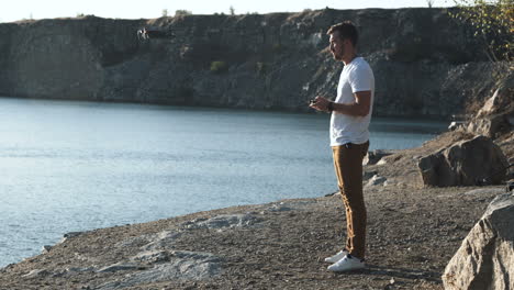man flying a drone over a quarry