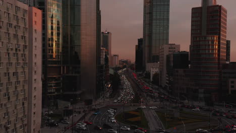 Large-city-downtown-landing-footage.-Heavy-traffic-on-wide-multilane-street-and-big-roundabout.-Warsaw,-Poland