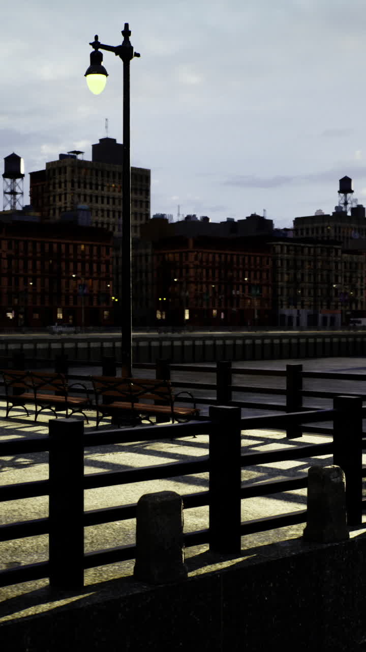 Sunset view over city waterfront with industrial buildings and reflections