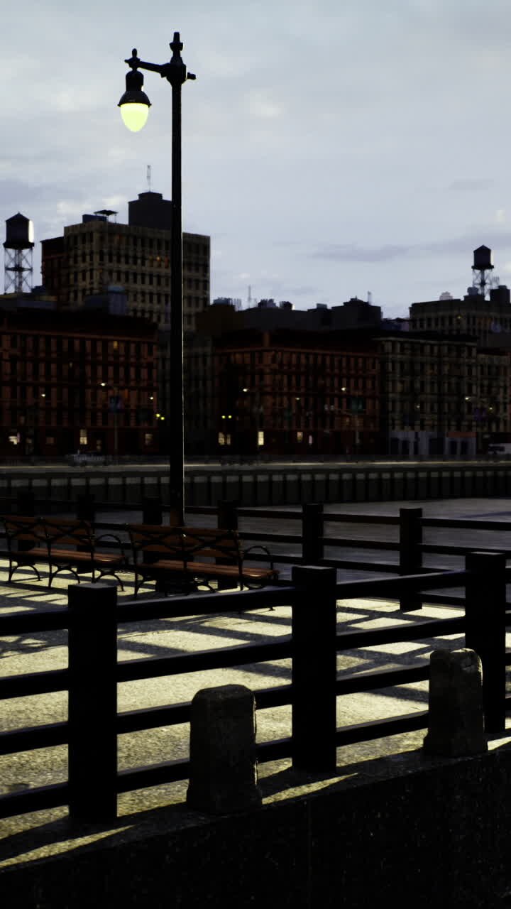 Sunset view over city waterfront with industrial buildings and reflections