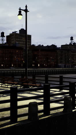 sunset view over city waterfront with industrial buildings and reflections