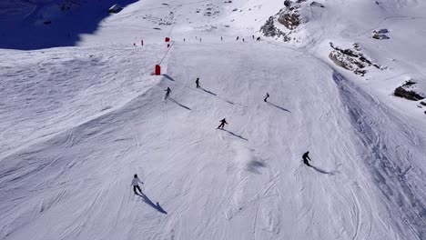 aerial view of skiers and snowboarders on a snowy mountain slope