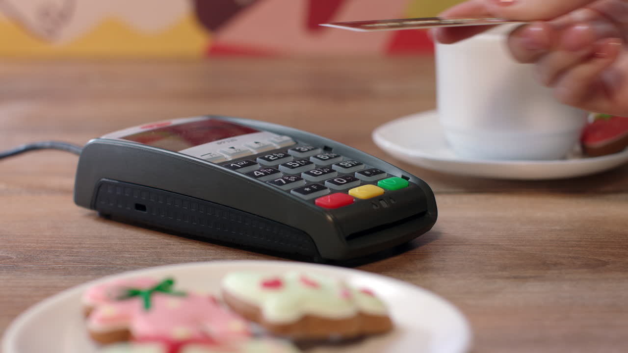 NFC credit card payment in cafe. Customer paying with contactless credit card