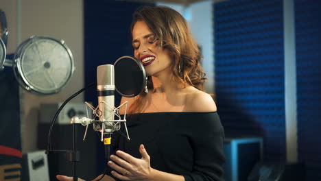 beautiful young singer who recorded a song in a professional recording studio. female vocal