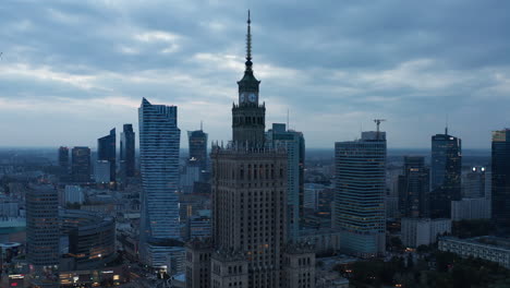 Palace-of-Culture-and-Science-at-dusk.-High-rise-buildings-in-city-centre.-Contrast-between-old-and-modern-tall-buildings.-Warsaw,-Poland