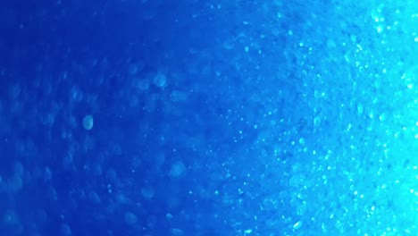 deep blue ocean color with swirling glitter and bubbles flickering and giving light pulses as they move, great calming background