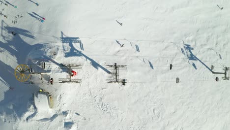 aerial dolly shot of an alpine ski lift on top of a mountain