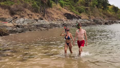 couple snorkeling on a beach