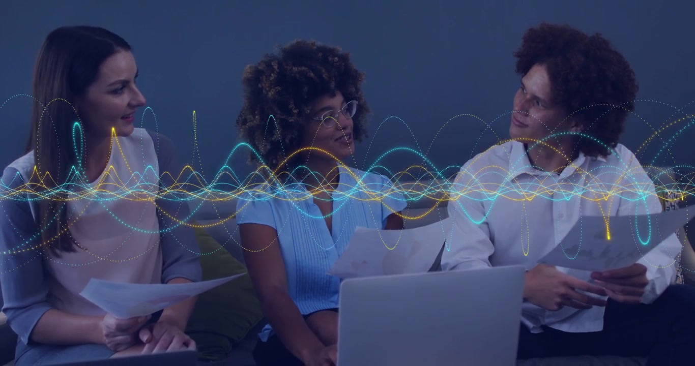 Team reviewing laptop, docs couch center glancing up, speaking, waveform showing talk for business