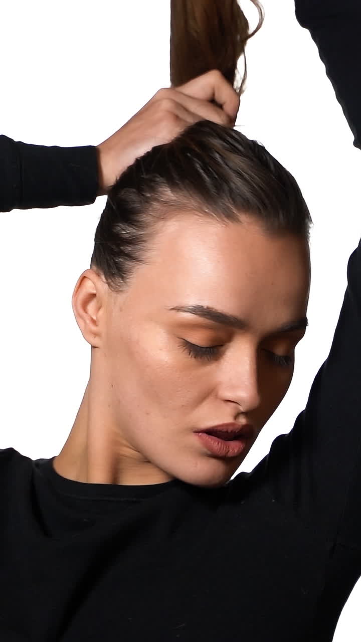 Pretty seriously model female. Portrait of seriously model woman posing on white background. Vertical video