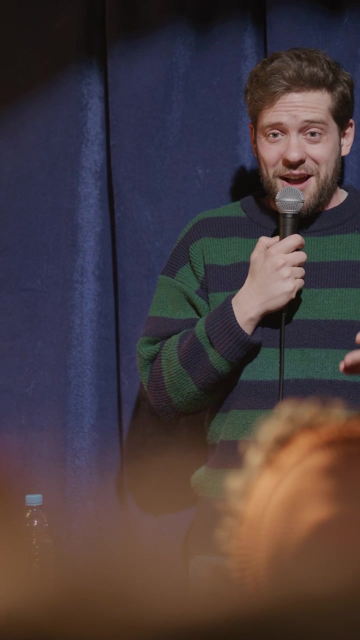 Comedian Sharing Story in front of Audience during Open Mic Night