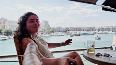 woman relaxing at cafe overlooking athens marina
