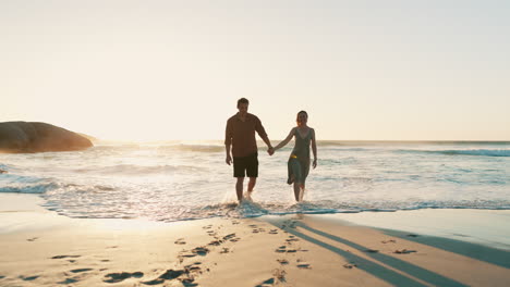Sunset,-beach-and-couple-holding-hands