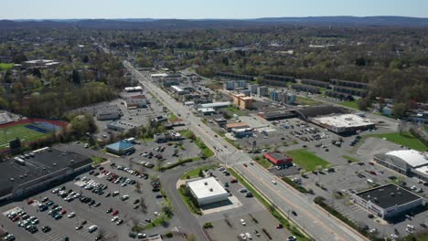 4k aerial drone footage of industrial shopping centers and strip malls in middletown new york and traffics can be seen with mountains in the background