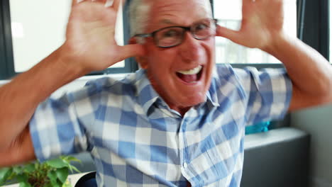 portrait of senior man making funny faces for camera