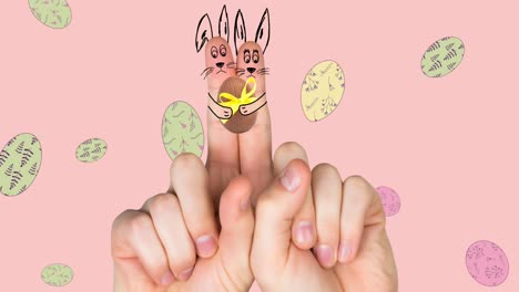 Animation-of-hand-with-easter-decorations-and-easter-eggs-over-pink-background