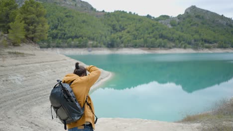 photographer taking pictures at a scenic lake