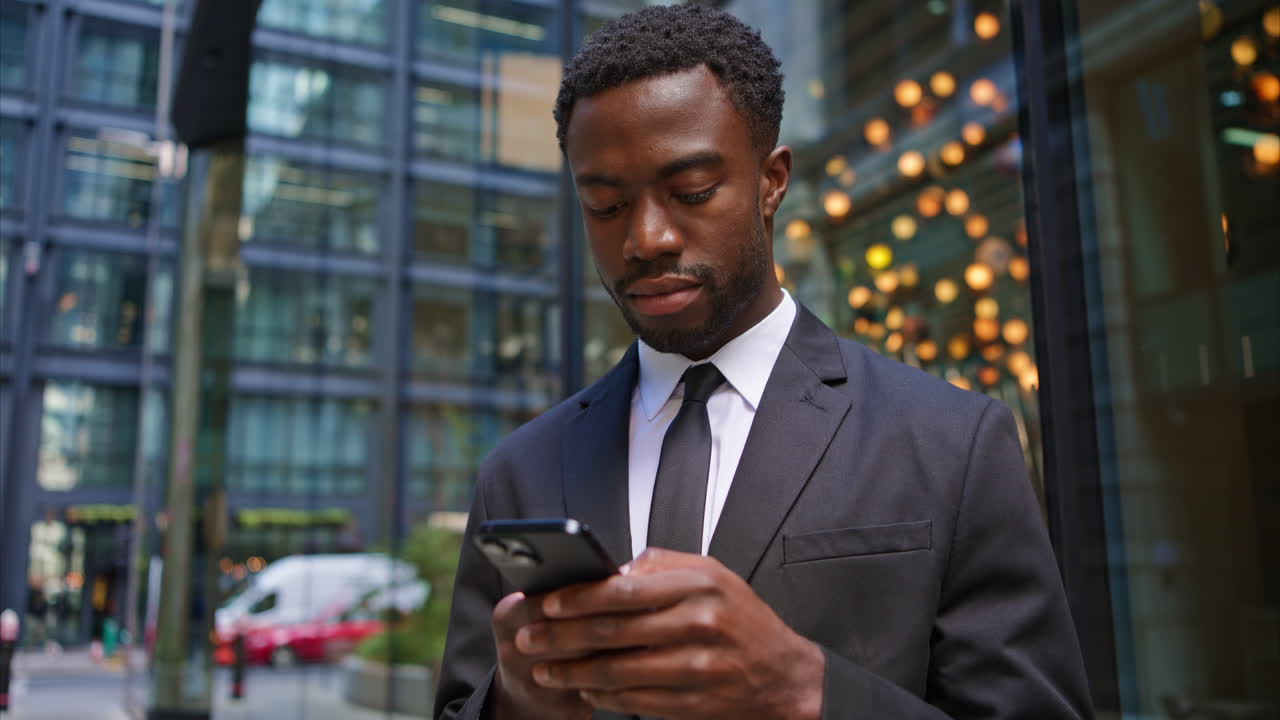 Young Businessman Wearing Suit Using Mobile Phone Outside Offices In The Financial District Of The City Of London UK Shot In Real Time 2