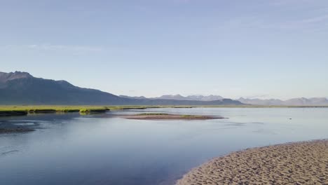 Low-Flight-Over-the-Sandy-River-Bank-During-Sunny-Summer-In-Snaefellsness-Peninsula,-Iceland