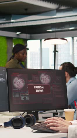 vertical video female programmer in startup office struggling to fix application errors