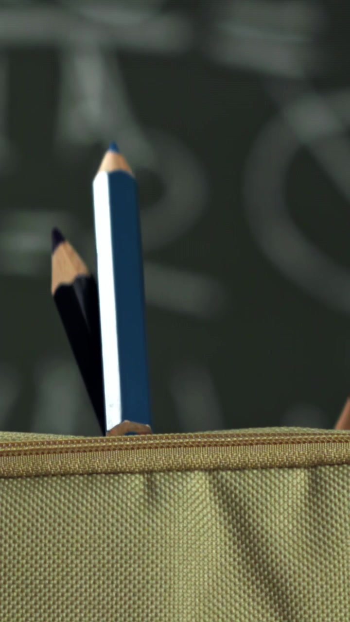 Colorful Pencils Falling into a Beige Pencil Case in Slow Motion