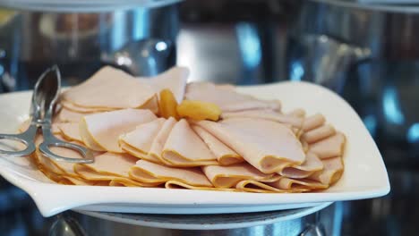 sliced ham on a buffet plate