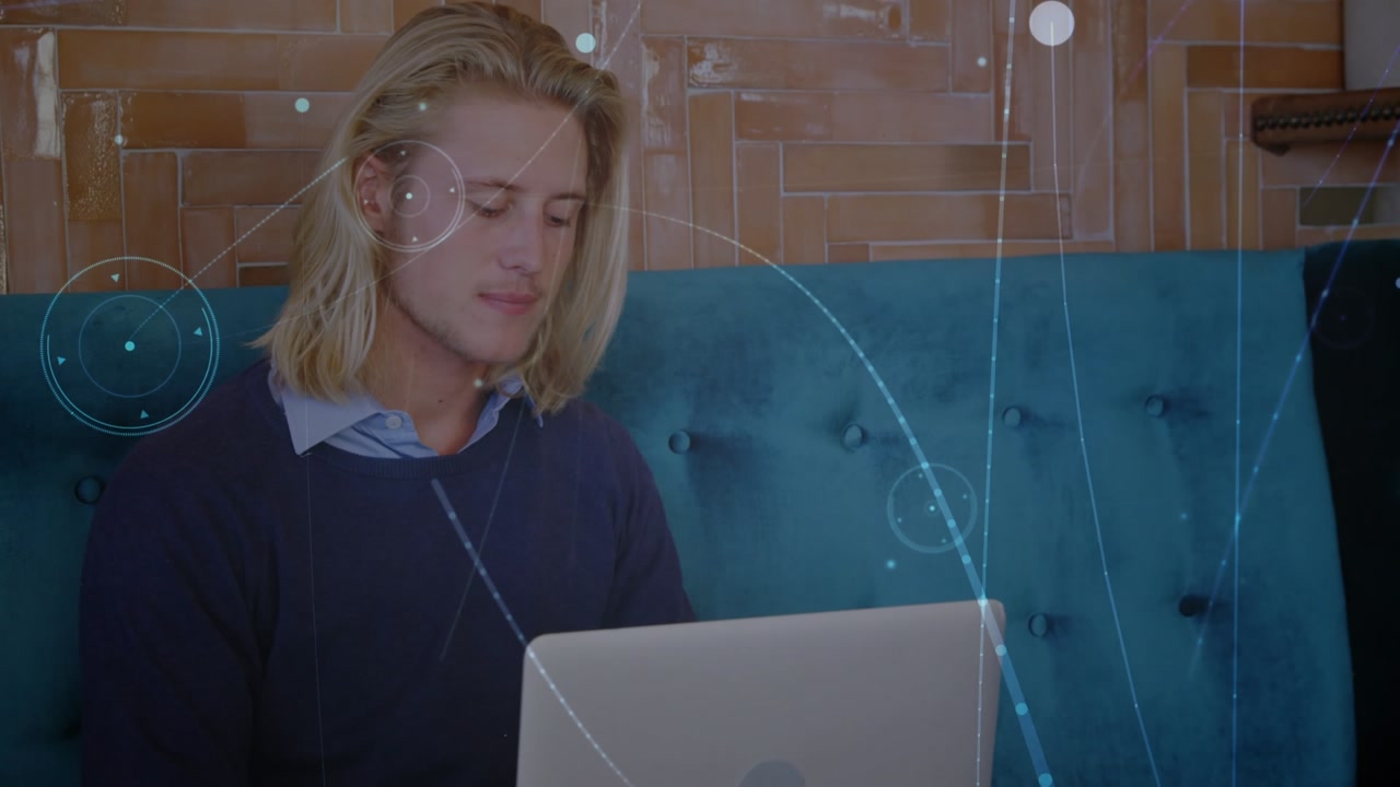Animation of network of connections over caucasian man using laptop