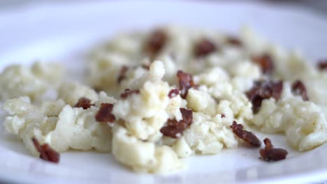 Halušky---traditional-slovak-food-on-plate-and-eating-with-fork-in-4k-UHD-video---Bryndzove-halusky,-traditional-national-slovak-food