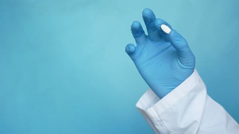 medical professional holding a pill